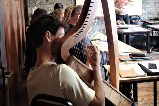 Students experiencing the harp in Irish music workshop (2)